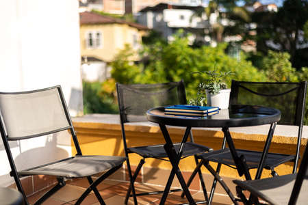 balcony with table and chairs in a sunny day. New normalの写真素材