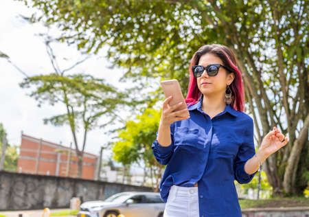 Young Woman Reading A Text Message In outdoors