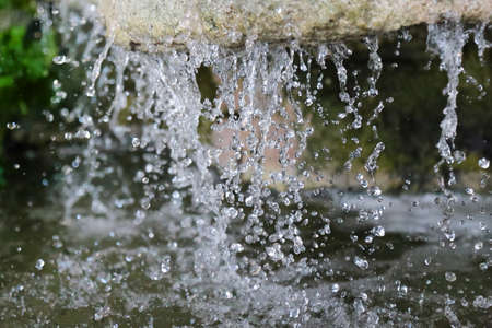 The rapid flow of water into the rockの写真素材