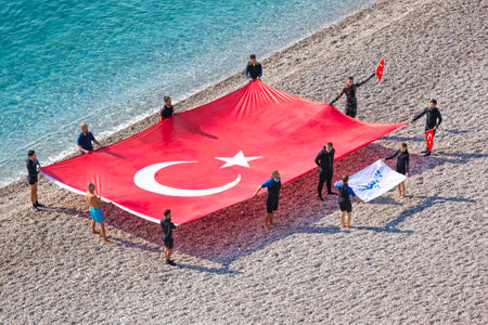 Divers celebrate Republic Day by opening the big Turkish flag on the Konyaalti beach of Antalya. October 2019のeditorial素材