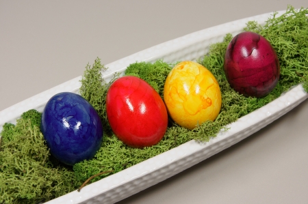 colorful eggs in a white bowl elongatedの写真素材