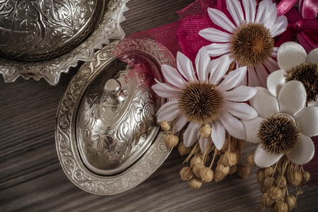Breakfast table ornament with silverware and flowers on wooden background