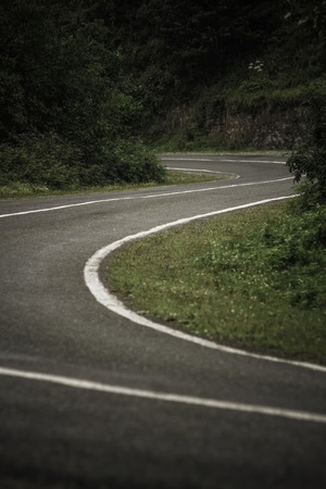 View of a curvy mountain road with a green landscapeの写真素材