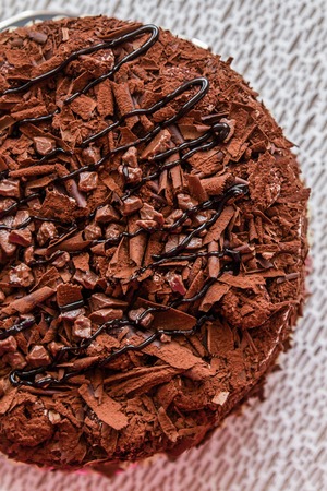 Homemade chocolate cake on a handmade white colored tableclothの写真素材