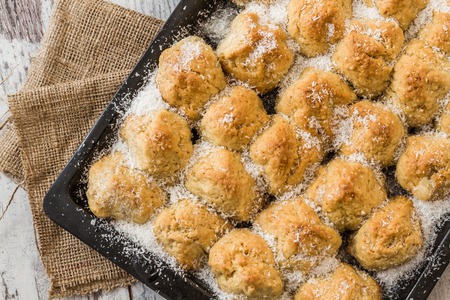 Small homemade Balkan dessert with coconuts on a black tray