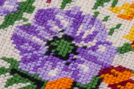 Cross stitch colorful flower embroidery on canvas