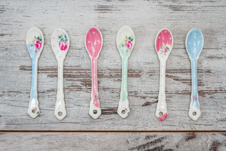 Cute colorful tea spoons on a wooden tableの写真素材