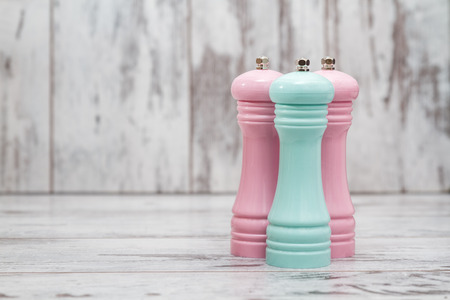 Colorful pepper mills on white wooden backgroundの写真素材