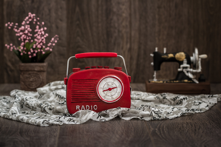 Decorative red radio with retro look on brown wooden backgroundの写真素材