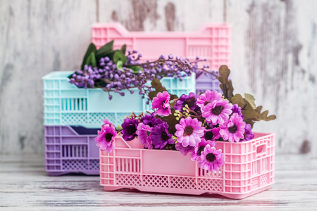 Colorful mini plastic cases with colorful flowers on white backgroundの写真素材