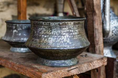 Big handmade forged copper cooking pots in an antique shop