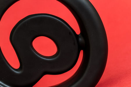 Decorative black email symbol on red backgroundの写真素材