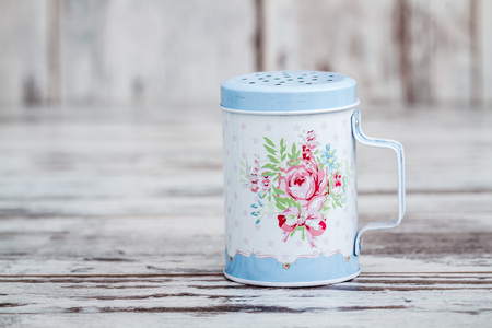 Blue tin metal powdered sugar shaker with floral patternの写真素材