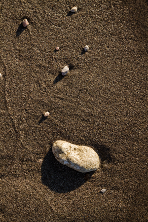 Sea pebbles on a clean beach as texture, backgroundの写真素材