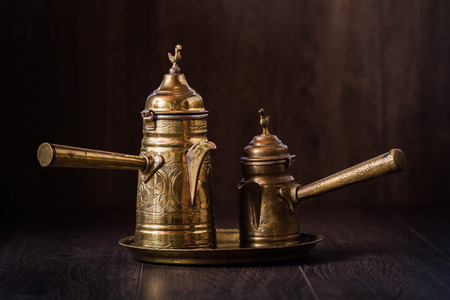 Vintage brass metal bitter coffee pots on brown backgroundの写真素材