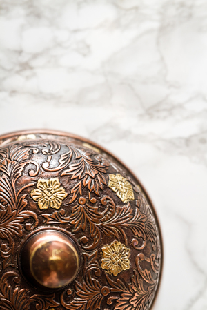 Handcrafted cupper service desk bell on marble backgroundのeditorial素材