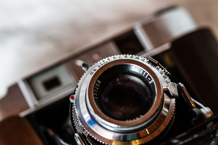 ESKISEHIR , TURKEY - AUGUST 28, 2018: Antique camera with leather holster on marble backgroundのeditorial素材