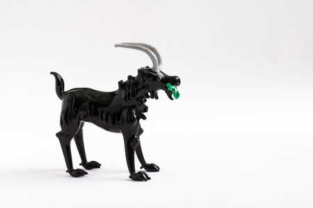 ESKISEHIR, TURKEY - DEC 1, 2016: Handmade wild sheep with hooked horn eating grass figurineのeditorial素材