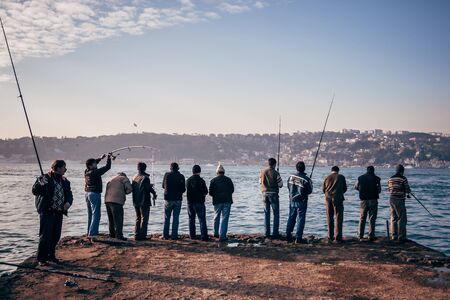 Istanbul, Turkey - Jan 20, 2008: People fishing on the Bosphorus in Cengelkoy, Kuleli coast