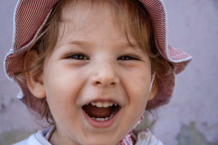 Cute baby smiling on snowy white , natural lookの写真素材