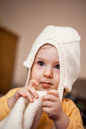 Cute baby girl getting dressed at home, natural look