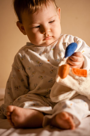 Cute baby girl looking in colorful bed, natural lookの写真素材