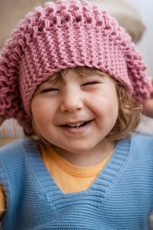 Cute newborn baby smiling in colorful bed, natural lookの写真素材