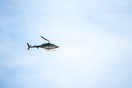 Helicopter flying in a clear blue sky, looking like frozen in the air.