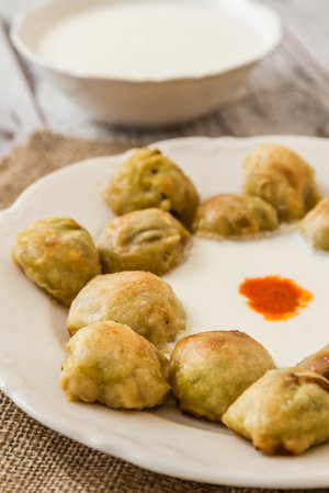 Bosnian pastry or manti served with yoghurt, a culinary delight from the Balkans.の写真素材