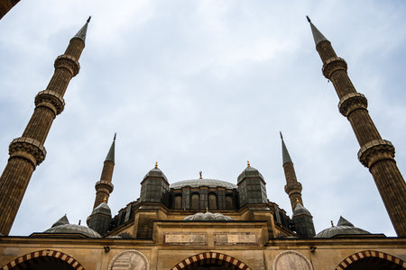 Low angle view of a mosque with four tall minarets against a cloudy sky, Mosque of Selim II, Edirne, Turkey.の写真素材