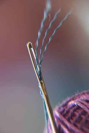 Harmonious appearance of the needle with blue and purple thread.の写真素材