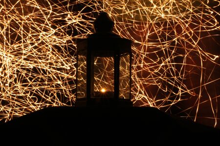 Silhouette of candle lamp with welding light