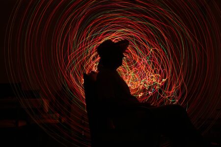 Silhouette of model in white, yellow, red, green shade of light.の写真素材