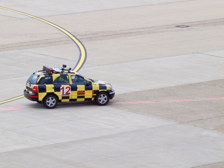 Marshaller in a car on the airport apron