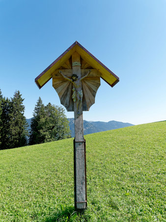 Wooden cross on a hiking trail in Bavaria.の写真素材