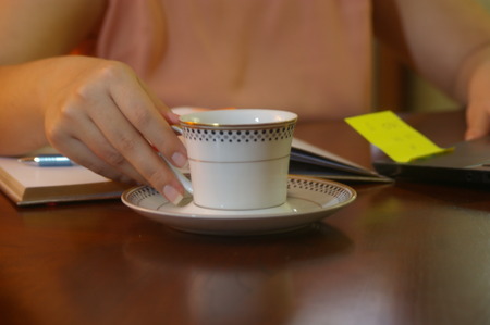 Woman holding a cup of tea on his labor dayの写真素材