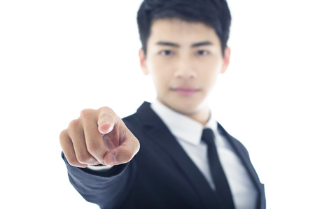 Portrait of young businessman pointing camera directionの写真素材