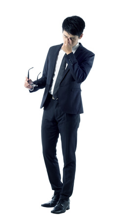 Portrait of tired young businessman taking off his glassesの写真素材