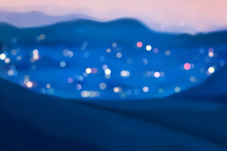 City at night with mountain surrounded, blurred lights at night