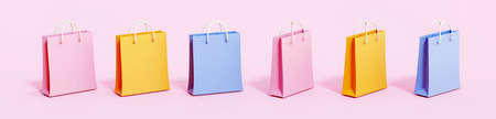 Colorful shopping bags in different angles. Elements isolated on pink background, 3d rendering.の写真素材