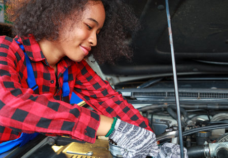 Female mechanic working on car
