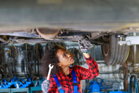 African Female auto mechanic working at the repair shop.の写真素材