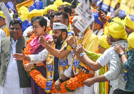 NEW DELHI, INDIA - MAY 4: AAP candidate from East Delhi Kuldeep Kumar for upcoming Loksabha Elections, along with Delhi minister and AAP leader Atishi seen during a Roadshow before filing the Nomination Papers for the Elections at Mandawali Area on May 4,のeditorial素材