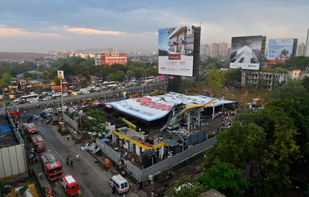 MUMBAI, INDIA - MAY 13: Ongoing rescue operation held by Mumbai Fire Brigade, NDRF, Mumbai Police and BMC at site after billboard fall on petrol pump following wind and dust storm at Ghatkopar on May 13, 2024 in Mumbai, India. At least eight people died, のeditorial素材