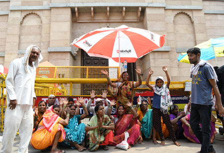 Varanasi, May 12, 2024 (ANI): Devotees sit outside the Kashi Vishwanath Temple to offer prayers, in Varanasi on Sunday. (ANI Photo via Hindustan Times/Shrikant Singh)のeditorial素材