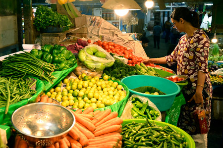 KOLKATA, INDIA - JULY 10: A woman is buying vegetables at VIP Market as prices of vegetables, potatoes, onions and other food items are very high on July 10, 2024 in Kolkata, India. (Photo by Samir Jana/Hindustan Times)のeditorial素材