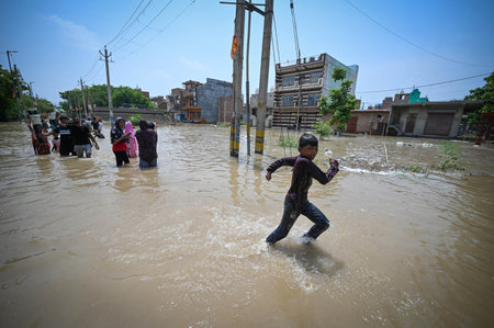 NEW DELHI, INDIA - JULY 11: Water from Munak canal entered inside the Block J of JJ Cluster after the Munak Canal breaches at Bawana on July 11, 2024 in New Delhi, India. A breach in the canal, that supplies water from Haryana to Delhi, entered the J, K aのeditorial素材