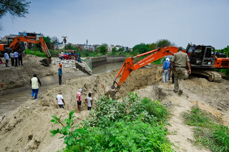 NEW DELHI, INDIA - JULY 12: Officials from various departments carrying out the repair work after the Munak canal breaches at Bawana on July 12, 2024 in New Delhi, India. A breach in the canal, that supplies water from Haryana to Delhi, entered the J, K aのeditorial素材