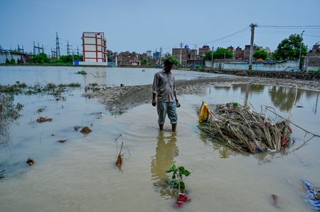 NEW DELHI, INDIA - JULY 12: Residents of JJ Colony seen, a day after the water from Munak canal enters the various blocks after breach in canal at Bawana on July 12, 2024 in New Delhi, India. A breach in the canal, that supplies water from Haryana to Delhのeditorial素材