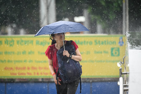 NEW DELHI, INDIA - JULY 18: People seen during sudden rainfall at Connaught Place on July 18, 2024 in New Delhi, India. The heavy rain in the national capital Delhi and surrounding areas brought relief to the people from the humid heat. However, the Meteoのeditorial素材
